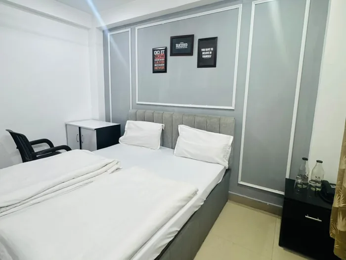 Guest room with a large bed and a chair